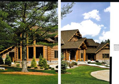 A two-page magazine spread features a luxurious log cabin surrounded by lush landscaping and tall trees. The cabin has a rustic design with large windows and stone accents. The sky is clear with a few clouds, creating a serene and picturesque setting.