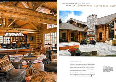 A magazine spread featuring a cozy, rustic log cabin home with a large stone chimney, surrounded by a paved patio. The interior shot showcases wooden beams, a chandelier, and comfortable seating arranged around a centerpiece rug. Text overlays describe cabin features.