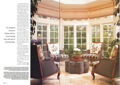 An octagonal sunroom with large windows and plenty of natural light. It features four French-inspired chairs with patterned upholstery, a round tufted ottoman table in the center, and potted plants around. Text is present on the left side of the image.